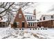 A view of the brick home with detailed architecture and a snow-covered yard at 5715 N Delaware St, Indianapolis, IN 46220
