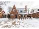 Charming brick two-story home featuring a classic design and snow-covered front yard at 5715 N Delaware St, Indianapolis, IN 46220