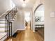 Inviting foyer with hardwood floors, elegant staircase, and view into the living areas at 5715 N Delaware St, Indianapolis, IN 46220