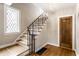 Well-lit foyer showcasing a decorative staircase, hardwood floors, and a classic design at 5715 N Delaware St, Indianapolis, IN 46220