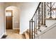 Foyer with hardwood floors, staircase with wrought iron railing, and arched doorway at 5715 N Delaware St, Indianapolis, IN 46220