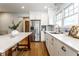 Updated kitchen with stainless steel fridge, white cabinets, and marble countertops at 5715 N Delaware St, Indianapolis, IN 46220