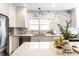 Modern kitchen boasts stainless steel appliances, marble backsplash, and white cabinets at 5715 N Delaware St, Indianapolis, IN 46220