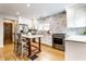 Modern kitchen features white cabinets, stainless steel appliances, and a marble backsplash at 5715 N Delaware St, Indianapolis, IN 46220