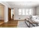 Living room featuring hardwood floors, a decorative rug, and a view to the kitchen at 5715 N Delaware St, Indianapolis, IN 46220