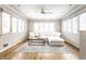 Bright living room with many windows, modern ceiling fan, and light-colored decor at 5715 N Delaware St, Indianapolis, IN 46220