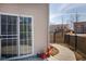 Back porch with sliding glass door overlooks the backyard, framed by a walkway and landscaping at 6236 White Rabbit Pl, Indianapolis, IN 46235