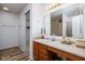 Bathroom with a vanity, large mirror, and combination shower and tub at 6236 White Rabbit Pl, Indianapolis, IN 46235