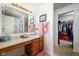 A well-lit bathroom with a large vanity and mirror along with an adjacent closet at 6236 White Rabbit Pl, Indianapolis, IN 46235