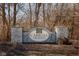 Stone entrance sign to the 'Carroll Crossing' community framed by trees and landscaping at 6236 White Rabbit Pl, Indianapolis, IN 46235
