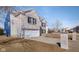 Light brick two-story home with black shutters, two-car garage, and concrete driveway at 6236 White Rabbit Pl, Indianapolis, IN 46235
