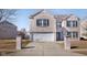 Two-story brick home featuring a two-car garage, double gable roof, and black shutters at 6236 White Rabbit Pl, Indianapolis, IN 46235