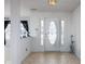 Bright foyer featuring a decorative glass front door and tile flooring leading into the home at 6236 White Rabbit Pl, Indianapolis, IN 46235