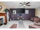 Living room featuring a fireplace, flat screen tv, ceiling fan, and neutral carpeting at 6236 White Rabbit Pl, Indianapolis, IN 46235