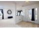Entryway to the living room featuring a large mirror and open floorplan with tan carpet at 6236 White Rabbit Pl, Indianapolis, IN 46235