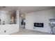 Minimalist-decorated living room featuring tan carpet, white walls, and a wall-mounted fireplace at 6236 White Rabbit Pl, Indianapolis, IN 46235