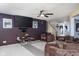 Spacious living room featuring a fireplace, flat screen tv, ceiling fan, and stairway access at 6236 White Rabbit Pl, Indianapolis, IN 46235