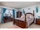 Comfortable main bedroom features neutral carpet, a large window, and a decorative bench at 6236 White Rabbit Pl, Indianapolis, IN 46235