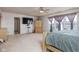 A spacious bedroom featuring neutral carpets, a large window, and an entertainment center at 6236 White Rabbit Pl, Indianapolis, IN 46235