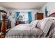 A spacious main bedroom features hardwood furniture, large windows, and neutral carpet at 6236 White Rabbit Pl, Indianapolis, IN 46235