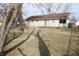 Large backyard with mature trees and grass, back patio door visible on home at 624 Park Dr, Greenwood, IN 46143