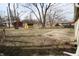 Large backyard with a wooden deck, storage shed, and mature trees at 624 Park Dr, Greenwood, IN 46143