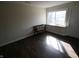 Empty bedroom featuring a bench, large window and hardwood floors at 624 Park Dr, Greenwood, IN 46143
