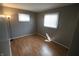 This is a bright bedroom with hardwood floors and natural light from two windows at 624 Park Dr, Greenwood, IN 46143
