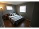 Relaxing bedroom featuring a plush bed and two bright windows at 624 Park Dr, Greenwood, IN 46143