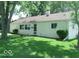 Well-maintained single-story home featuring a lush green lawn and mature trees at 624 Park Dr, Greenwood, IN 46143