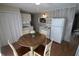 Cozy kitchen featuring white appliances, plenty of storage, and a dining area at 624 Park Dr, Greenwood, IN 46143