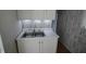 Kitchen featuring a stainless steel double sink and faux wood backsplash at 624 Park Dr, Greenwood, IN 46143