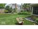 Well-maintained backyard with lush green grass, landscaping and comfortable wooden chair at 6564 Aintree Pl, Indianapolis, IN 46250