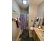 Cozy bathroom with a shower, vanity sink, tile flooring, and wall decorations at 6564 Aintree Pl, Indianapolis, IN 46250