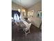 A dining room featuring a modern chandelier and a pass through to the kitchen at 6564 Aintree Pl, Indianapolis, IN 46250