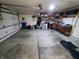 Spacious garage with storage shelves, concrete floors, and a functional door at 6564 Aintree Pl, Indianapolis, IN 46250