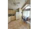 Eat-in kitchen featuring tile floors, cream colored cabinets, a breakfast nook and vaulted ceiling at 6564 Aintree Pl, Indianapolis, IN 46250