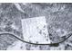 Aerial view of the snow-covered property, house, trees, and the surrounding area at 7166 N Oak Ridge Rd, Morgantown, IN 46160