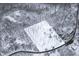 Aerial view of the snow-covered property, house, trees, and the surrounding area at 7166 N Oak Ridge Rd, Morgantown, IN 46160