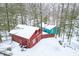 Aerial view of a red outbuilding and teal house surrounded by a snowy forest at 7166 N Oak Ridge Rd, Morgantown, IN 46160