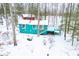 Aerial view showcases the turquoise home, nestled among snow-covered trees, with a charming exterior at 7166 N Oak Ridge Rd, Morgantown, IN 46160