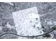 Aerial view of the snow-covered property, house, trees, road, and the surrounding area at 7166 N Oak Ridge Rd, Morgantown, IN 46160