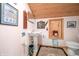Small bathroom with pedestal sink, toilet, and wood ceilings at 7166 N Oak Ridge Rd, Morgantown, IN 46160