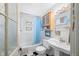 Bright bathroom featuring a classic pedestal sink and a blue shower curtain at 7166 N Oak Ridge Rd, Morgantown, IN 46160