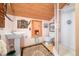 Small bathroom with pedestal sink, toilet, shower, and wood ceilings at 7166 N Oak Ridge Rd, Morgantown, IN 46160