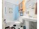 Bright bathroom with classic black and white tile floor and blue shower curtain at 7166 N Oak Ridge Rd, Morgantown, IN 46160