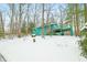 Turquoise house with snow-covered yard, deck, and natural surroundings provides serene outdoor living at 7166 N Oak Ridge Rd, Morgantown, IN 46160
