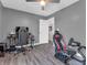 A bedroom with hard surface floors and two gaming chairs set up for the ultimate gaming experience at 976 Cherry Tree Ln, Greenwood, IN 46143