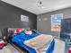 bedroom with a dark accent wall, stuffed animals on bed, and a metal locker for storage at 976 Cherry Tree Ln, Greenwood, IN 46143