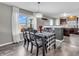 Bright dining area with a modern chandelier, wood floors, and a large window with natural light at 976 Cherry Tree Ln, Greenwood, IN 46143